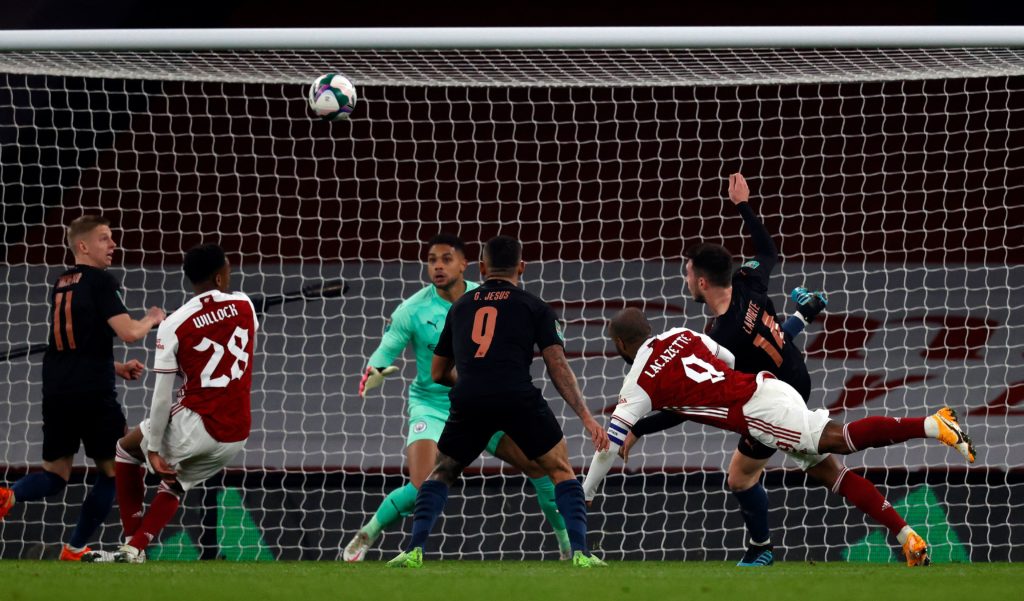 Arsenal's French striker Alexandre Lacazette (2R) scores the equalising goal during the English League Cup quarter final football match between Arsenal and Manchester City at the Emirates Stadium, in London on December 22, 2020. (Photo by ADRIAN DENNIS/AFP via Getty Images)