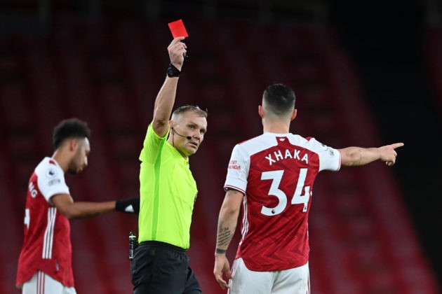 Referee Graham Scott shows the red card to send off Arsenal's Swiss midfielder Granit Xhaka (R) during the English Premier League football match between Arsenal and Burnley at the Emirates Stadium in London on December 13, 2020. (Photo by Laurence Griffiths / POOL / AFP)