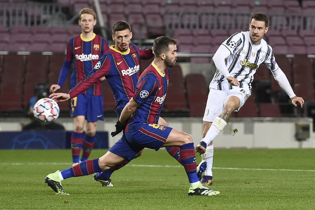Juventus' Welsh midfielder Aaron Ramsey (R) kicks the ball past Barcelona's Bosnian midfielder Miralem Pjanic (C) and Barcelona's French defender Clement Lenglet during the UEFA Champions League group G football match between Barcelona and Juventus at the Camp Nou stadium in Barcelona on December 8, 2020. (Photo by JOSEP LAGO/AFP via Getty Images)