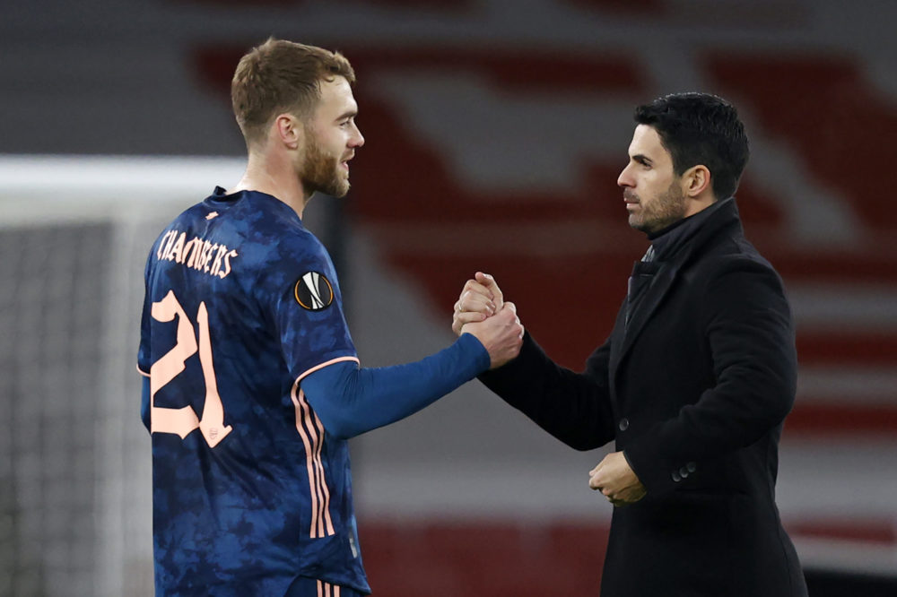 Arsenal's Spanish manager Mikel Arteta congratulates Arsenal's English defender Calum Chambers (L) on the pitch after the UEFA Europa League 1st Round Group B football match between Arsenal and Rapid Vienna at the Emirates Stadium in London on December 3, 2020. - Arsenal won the game 4-1. (Photo by Adrian DENNIS / AFP)