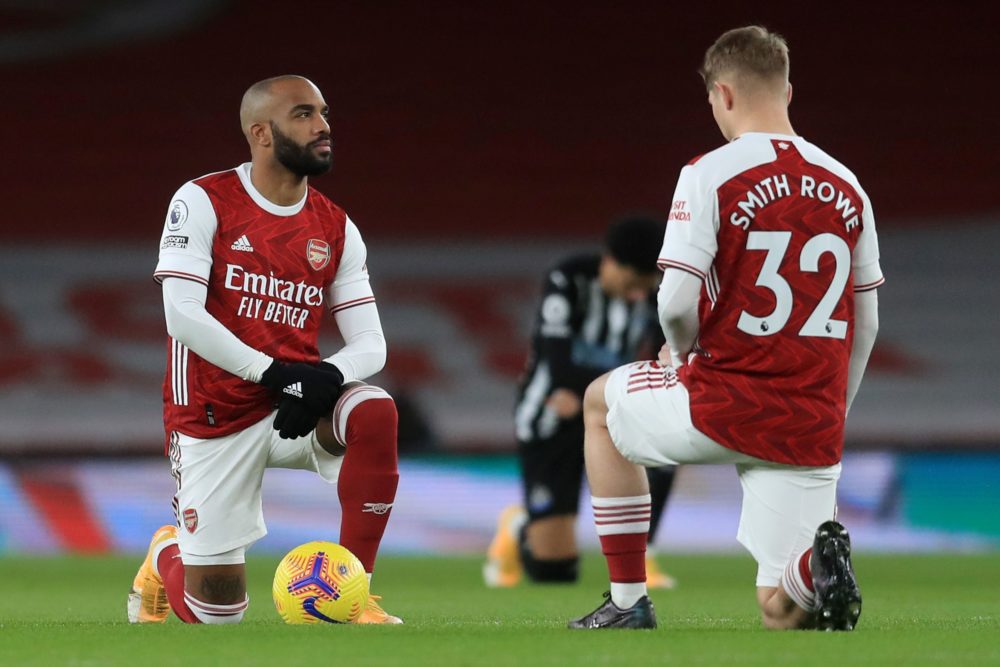 Arsenal's French striker Alexandre Lacazette (L) and Arsenal's English midfielder Emile Smith Rowe take the knee in support of the No Room For Racism campaign during the English Premier League football match between Arsenal and Newcastle United at the Emirates Stadium in London on January 18, 2021. (Photo by Adam Davy / POOL / AFP)