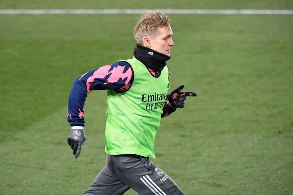 Real Madrid's Norwegian midfielder Martin Odegaard warms up on the sidelines during the Spanish League football match between Real Madrid and Celta Vigo at the Alfredo Di Stefano stadium in Valdebebas, northeast of Madrid, on January 2, 2021. (Photo by OSCAR DEL POZO / AFP)