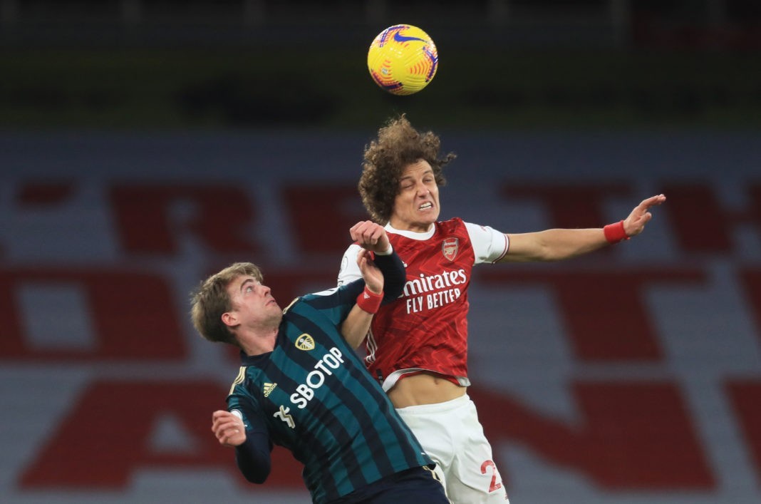LONDON, ENGLAND - FEBRUARY 14: David Luiz of Arsenal wins a header over Patrick Bamford of Leeds United during the Premier League match between Arsenal and Leeds United at Emirates Stadium on February 14, 2021 in London, England. Sporting stadiums around the UK remain under strict restrictions due to the Coronavirus Pandemic as Government social distancing laws prohibit fans inside venues resulting in games being played behind closed doors. (Photo by Adam Davy - Pool/Getty Images)