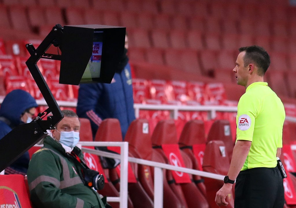 Referee Stuart Attwell views a VAR screen after Leeds United's Liam Cooper fouled Arsenal's English striker Bukayo Saka during the English Premier League football match between Arsenal and Leeds United at the Emirates Stadium in London on February 14, 2021. (Photo by CATHERINE IVILL/POOL/AFP via Getty Images)