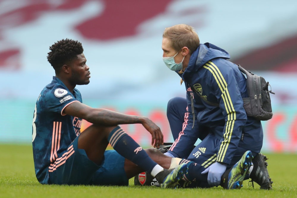 Arsenal's Ghanaian midfielder Thomas Partey receives medical attention during the English Premier League football match between Aston Villa and Arsenal at Villa Park in Birmingham, central England on February 6, 2021. (Photo by Catherine Ivill / POOL / AFP)