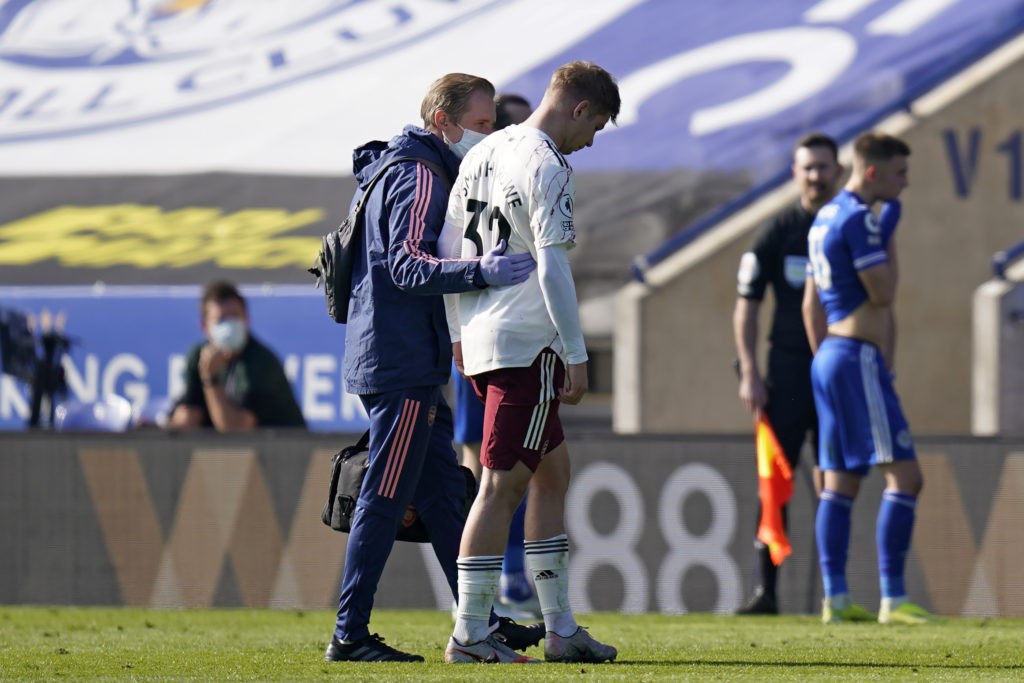 Arsenal's English midfielder Emile Smith Rowe is helped from the pitch after picking up an injury during the English Premier League football match between Leicester City and Arsenal at King Power Stadium in Leicester, central England on February 28, 2021. (Photo by TIM KEETON/POOL/AFP via Getty Images)