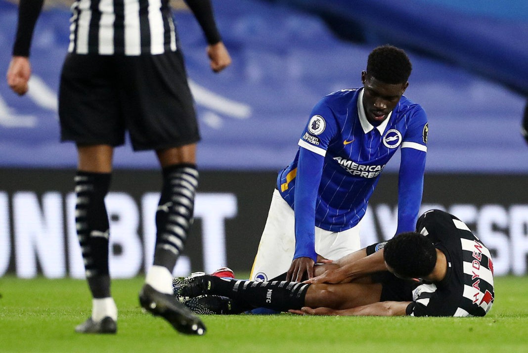 Isaac Hayden of Newcastle United is seen on the floor with an injury on 20th March 2021. Brighton & Hove Albion v Newcastle United, Premier League. Photo by James Marsh/BPI/Shutterstock