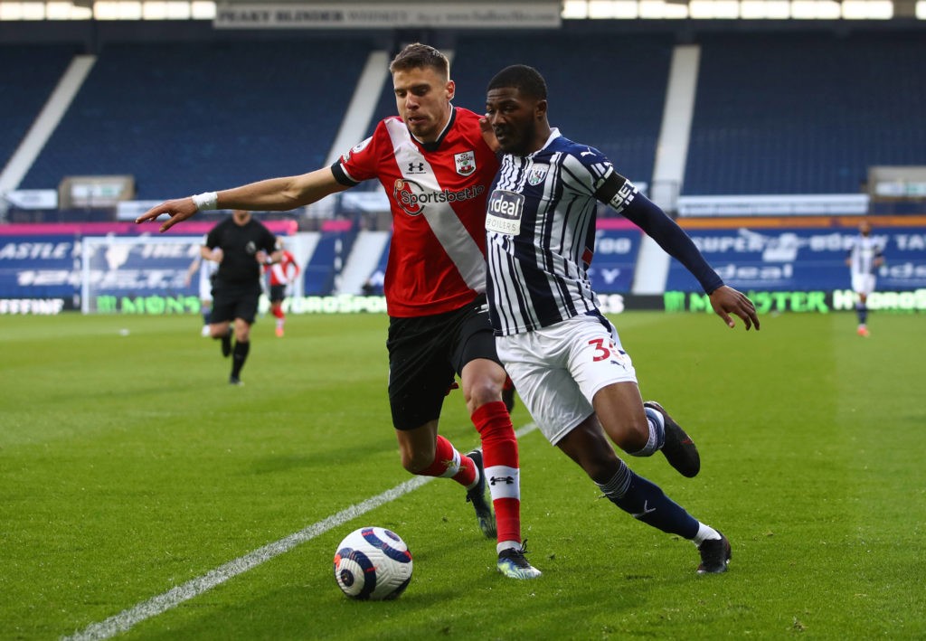 West Bromwich Albion's Ainsley Maitland-Niles and Southampton's Jan Bednarek (left) battle for the ball during the Premier League match at The Hawthorns, West Bromwich. Picture date: Monday, April 12, 2021. Copyright: Michael Steele