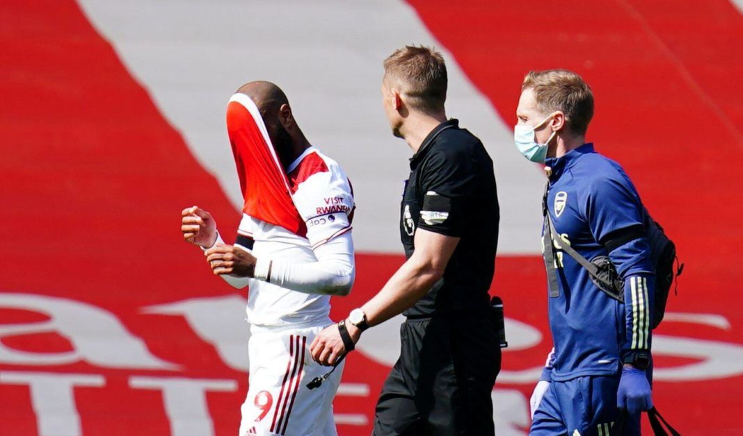 Alexandre Lacazette of Arsenal covers his face with his shirt as he goes off injured Arsenal v Fulham, Premier League, Football, The Emirates Stadium, London, UK - 18 Apr 2021 Photo by Javier Garcia/BPI/Shutterstock