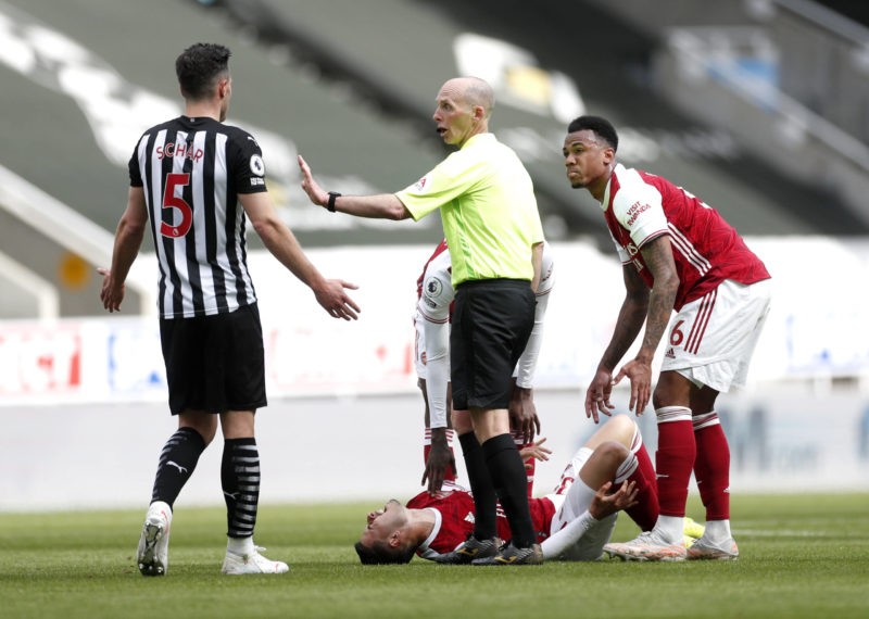 Fabian Schar left receives a red card from referee Mike Dean after fouling Arsenal s Gabriel Martinelli during the Premier League match at St James Park, Newcastle upon Tyne. Copyright: Lee Smith