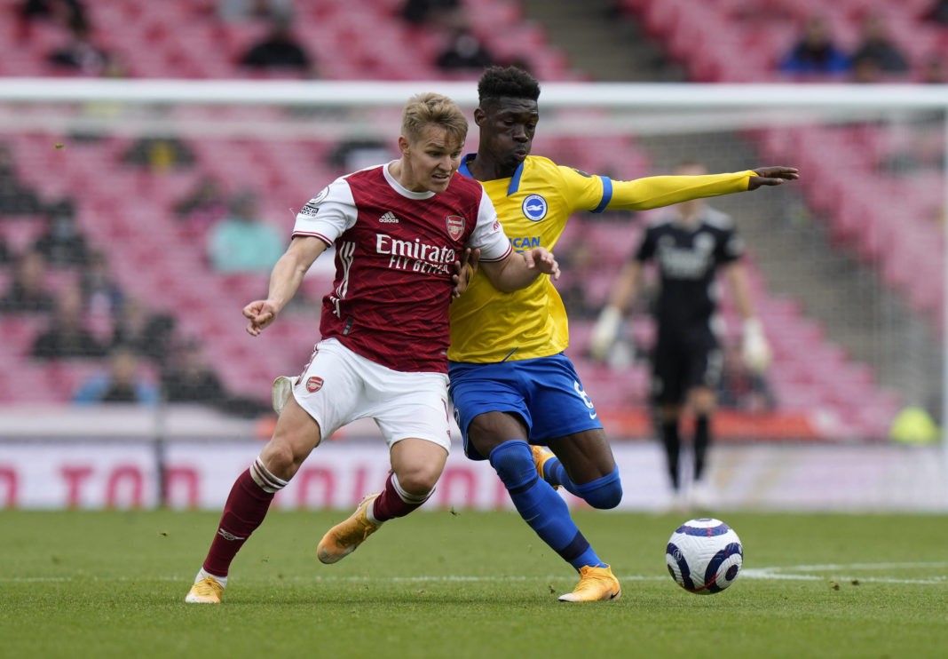 Arsenal's Martin Odegaard and Brighton and Hove Albion's Yves Bissouma battle for the ball during the Premier League match at the Emirates Stadium, London. Picture date: Sunday, May 23, 2021. Copyright: Alastair Grant