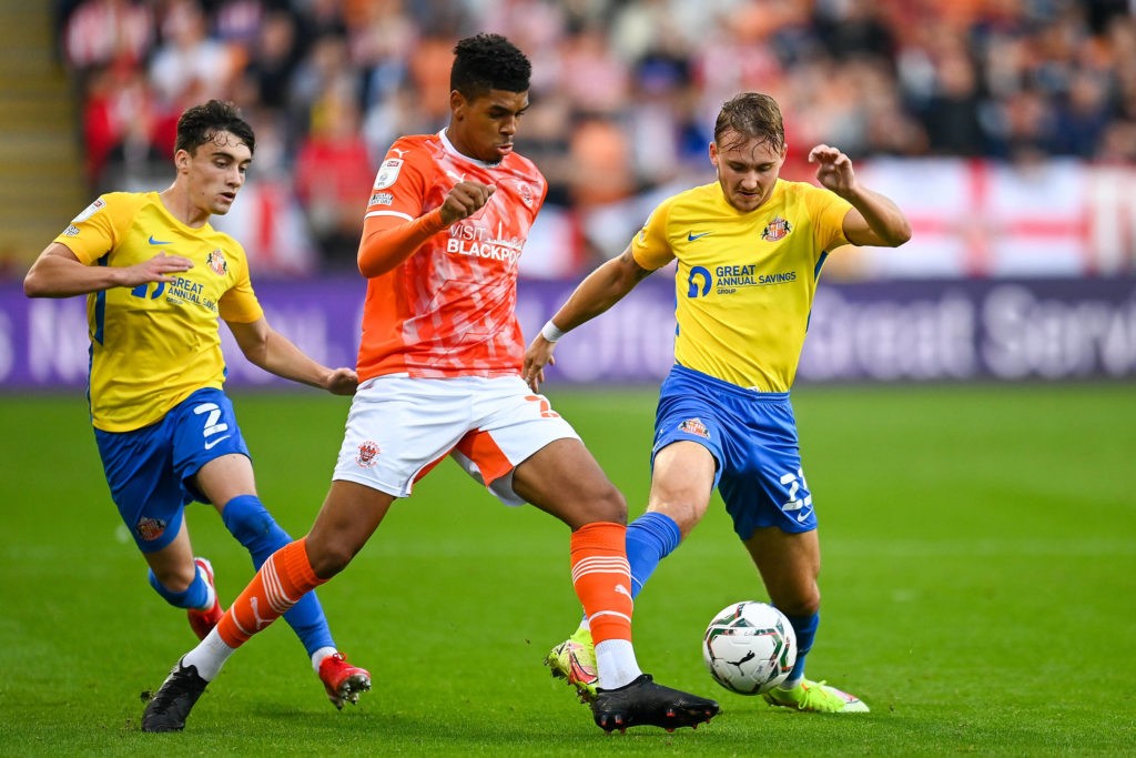 Tyreece John-Jules of Blackpool FC is surrounded by Niall Huggins of Sunderland AFC and Jack Diamond of Sunderland AFC during the EFL Carabao Cup match between Blackpool and Sunderland at Bloomfield Road, Blackpool, England on 24 August 2021. Copyright: Malcolm Mackenzie