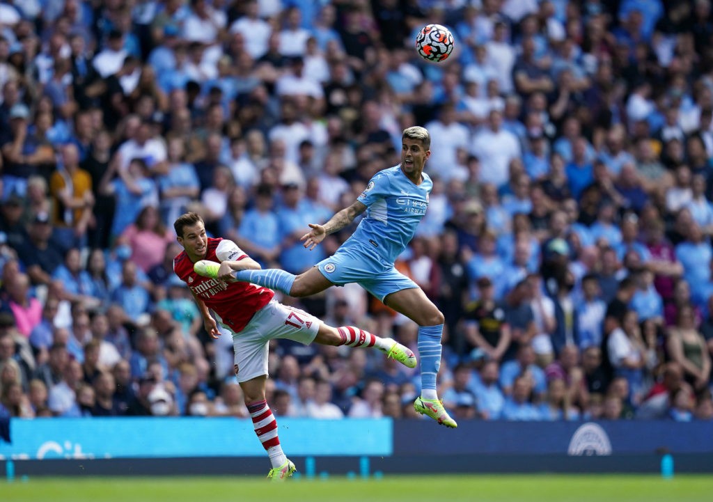 Manchester City v Arsenal - Premier League - Etihad Stadium Arsenals Cedric Soares left and Manchester City s Joao Cancelo battle for the ball in the air during the Premier League match at the Etihad Stadium, Manchester. Picture date: Saturday August 28, 2021. Copyright: Nick Potts