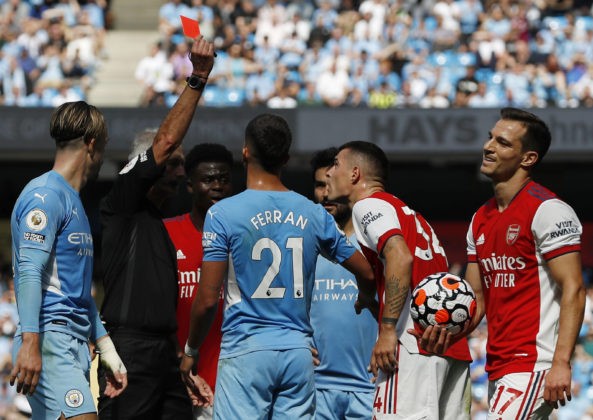 Manchester, England, 28th August 2021. Granit Xhaka of Arsenal is shown a red card by referee Martin Atkinson during the Premier League match at the Etihad Stadium, Manchester. Picture credit should read: Darren Staples / Sportimage