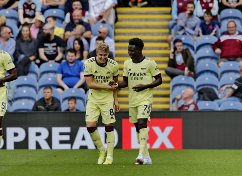 Football - 2021 / 2022 Premier League - Burnley vs. Arsenal Martin Odegaard of Arsenal celebrates with Bukayo Saka after he curls a free kick around the Burnley wall to put his team 1-0 ahead in the first half, at Turf Moor. COLORSPORT/ALAN MARTIN