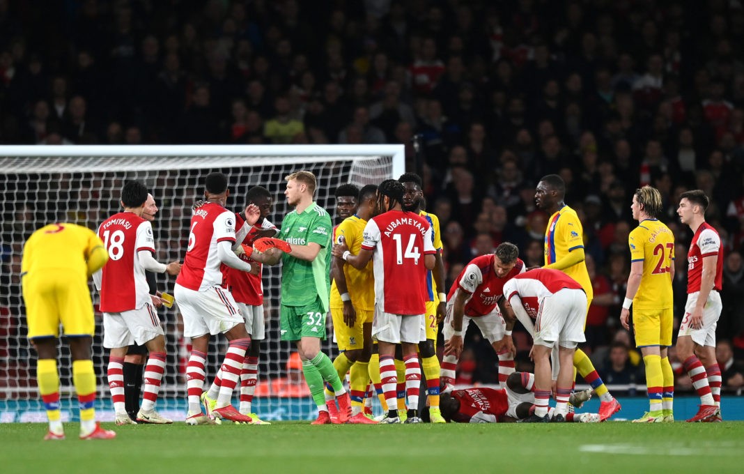 LONDON, ENGLAND - OCTOBER 18: Aaron Ramsdale and Nicolas Pepe hold back Gabriel Magalhaes of Arsenal after a foul on Bukayo Saka during the Premier League match between Arsenal and Crystal Palace at Emirates Stadium on October 18, 2021 in London, England. (Photo by Shaun Botterill/Getty Images)