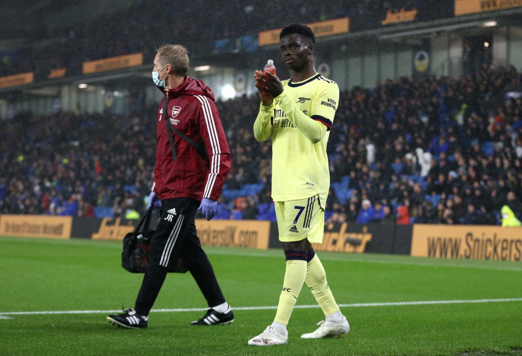 BRIGHTON, ENGLAND: Bukayo Saka of Arsenal applauds fans after being substituted after an injury during the Premier League match between Brighton & Hove Albion and Arsenal at American Express Community Stadium on October 02, 2021. (Photo by Steve Bardens/Getty Images)