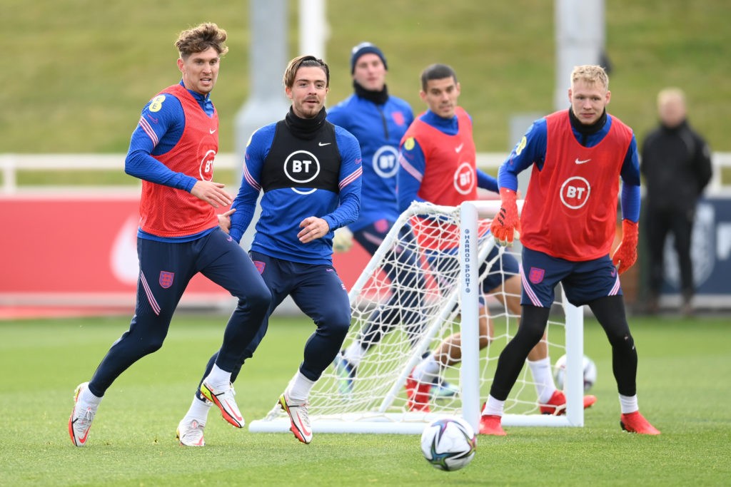 BURTON-UPON-TRENT, ENGLAND - OCTOBER 05: John Stones, Jack Grealish and Aaron Ramsdale watch a loose ball during a training session at St Georges Park on October 05, 2021 in Burton-upon-Trent, England. (Photo by Michael Regan/Getty Images)