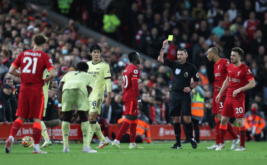 LIVERPOOL, ENGLAND: Sadio Mane of Liverpool is shown a yellow card by Match Referee Michael Oliver during the Premier League match between Liverpool and Arsenal at Anfield on November 20, 2021. (Photo by Clive Brunskill/Getty Images)