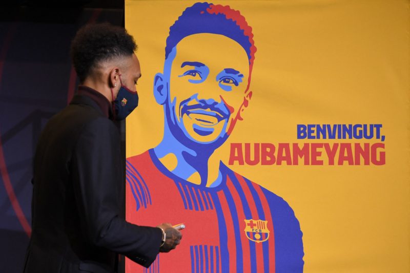 Barcelona's new player Gabonese forward Pierre-Emerick Aubameyang stands next to a poster reading "welcome Aubameyang" during a press conference for his official presentation, at the Camp Nou stadium in Barcelona on February 3, 2022. (Photo by LLUIS GENE / AFP) (Photo by LLUIS GENE/AFP via Getty Images)