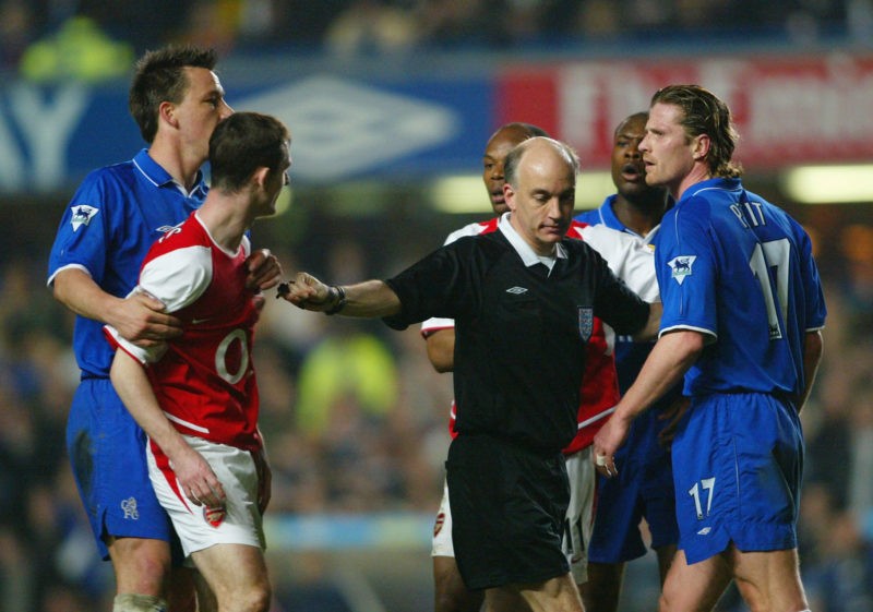 LONDON - MARCH 25: Referee David Elleray gets in between Francis Jeffers of Arsenal as he goes head to head with Emmanuel Petit of Chelsea during the FA Cup Quarter Final Replay match between Chelsea and Arsenal at Stamford Bridge in London on March 25, 2003. (Photo By Ben Radford/Getty Images)