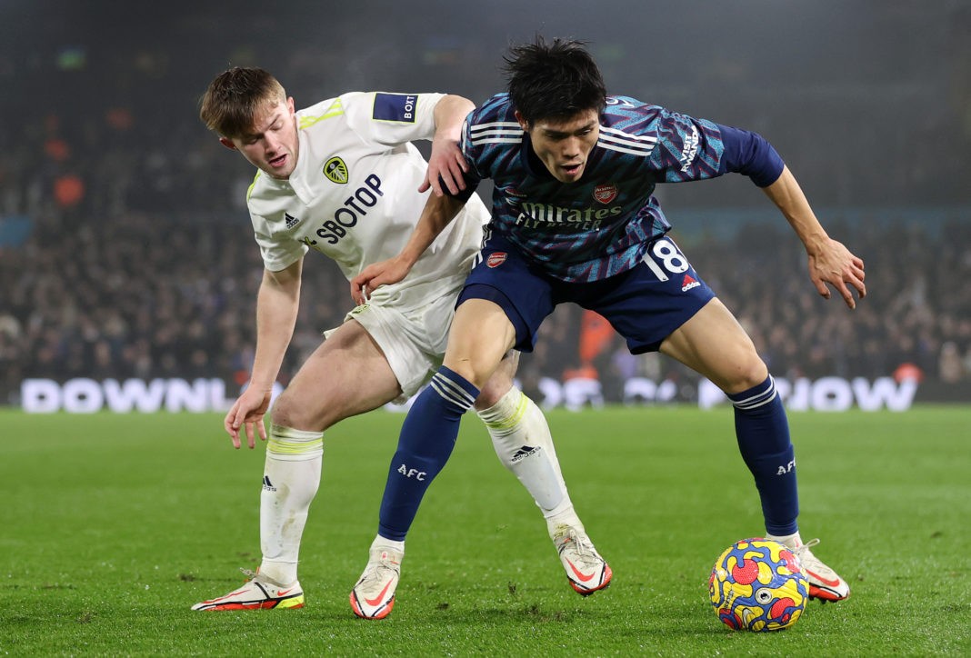 LEEDS, ENGLAND - DECEMBER 18: Joe Gelhardt of Leeds United battles for possession with Takehiro Tomiyasu of Arsenal during the Premier League match between Leeds United and Arsenal at Elland Road on December 18, 2021 in Leeds, England. (Photo by Naomi Baker/Getty Images)