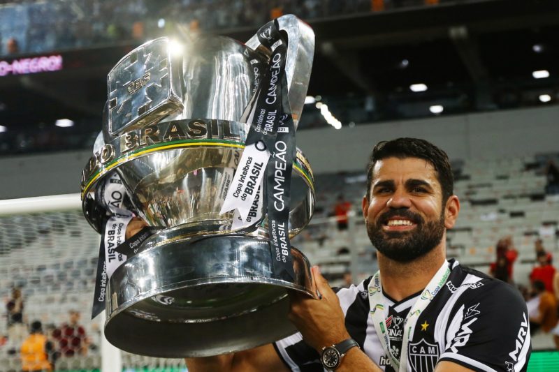 Atletico Mineiro's Diego Costa celebrates with the trophy after his team won the 2021 Brazil Cup second leg final football match against Athletico Paranaense at the Arena da Baixada stadium in Curitiba, Brazil, on December 15, 2021. (Photo by Heuler Andrey / AFP) (Photo by HEULER ANDREY/AFP via Getty Images)