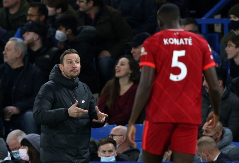Liverpool's Dutch assistant manager Pepijn Lijnders (L) reacts during the English Premier League football match between Chelsea and Liverpool at Stamford Bridge in London on January 2, 2022. - RESTRICTED TO EDITORIAL USE. No use with unauthorized audio, video, data, fixture lists, club/league logos or 'live' services. Online in-match use limited to 120 images. An additional 40 images may be used in extra time. No video emulation. Social media in-match use limited to 120 images. An additional 40 images may be used in extra time. No use in betting publications, games or single club/league/player publications. (Photo by Adrian DENNIS / AFP) / RESTRICTED TO EDITORIAL USE. No use with unauthorized audio, video, data, fixture lists, club/league logos or 'live' services. Online in-match use limited to 120 images. An additional 40 images may be used in extra time. No video emulation. Social media in-match use limited to 120 images. An additional 40 images may be used in extra time. No use in betting publications, games or single club/league/player publications. / RESTRICTED TO EDITORIAL USE. No use with unauthorized audio, video, data, fixture lists, club/league logos or 'live' services. Online in-match use limited to 120 images. An additional 40 images may be used in extra time. No video emulation. Social media in-match use limited to 120 images. An additional 40 images may be used in extra time. No use in betting publications, games or single club/league/player publications. (Photo by ADRIAN DENNIS/AFP via Getty Images)