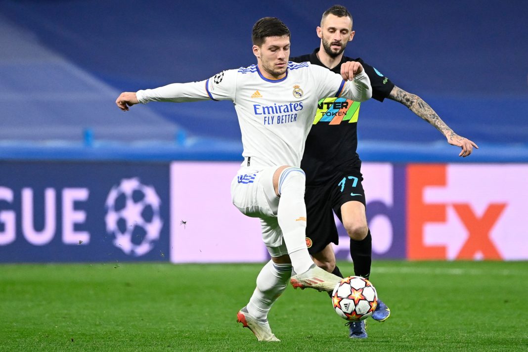 Real Madrid's Serbian forward Luka Jovic (L) fights for the ball with Inter Milan's Croatian midfielder Marcelo Brozovic during the UEFA Champions League first-round group D football match between Real Madrid and Inter Milan at the Santiago Bernabeu stadium in Madrid on December 7, 2021. (Photo by PIERRE-PHILIPPE MARCOU/AFP via Getty Images)