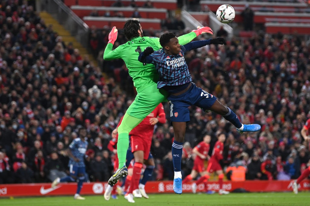 LIVERPOOL, ENGLAND - JANUARY 13: Eddie Nketiah of Arsenal is challenged by Alisson Becker of Liverpool during the Carabao Cup Semi Final First Leg match between Liverpool and Arsenal at Anfield on January 13, 2022 in Liverpool, England. (Photo by Michael Regan/Getty Images)