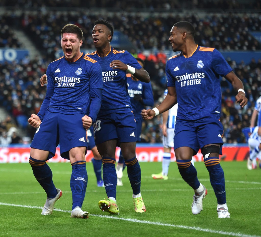SAN SEBASTIAN, SPAIN: Luka Jovic of Real Madrid celebrates with teammates Vinicius Junior and David Alaba after scoring their side's second goal during the La Liga Santander match between Real Sociedad and Real Madrid CF at Reale Arena on December 04, 2021. (Photo by Juan Manuel Serrano Arce/Getty Images)
