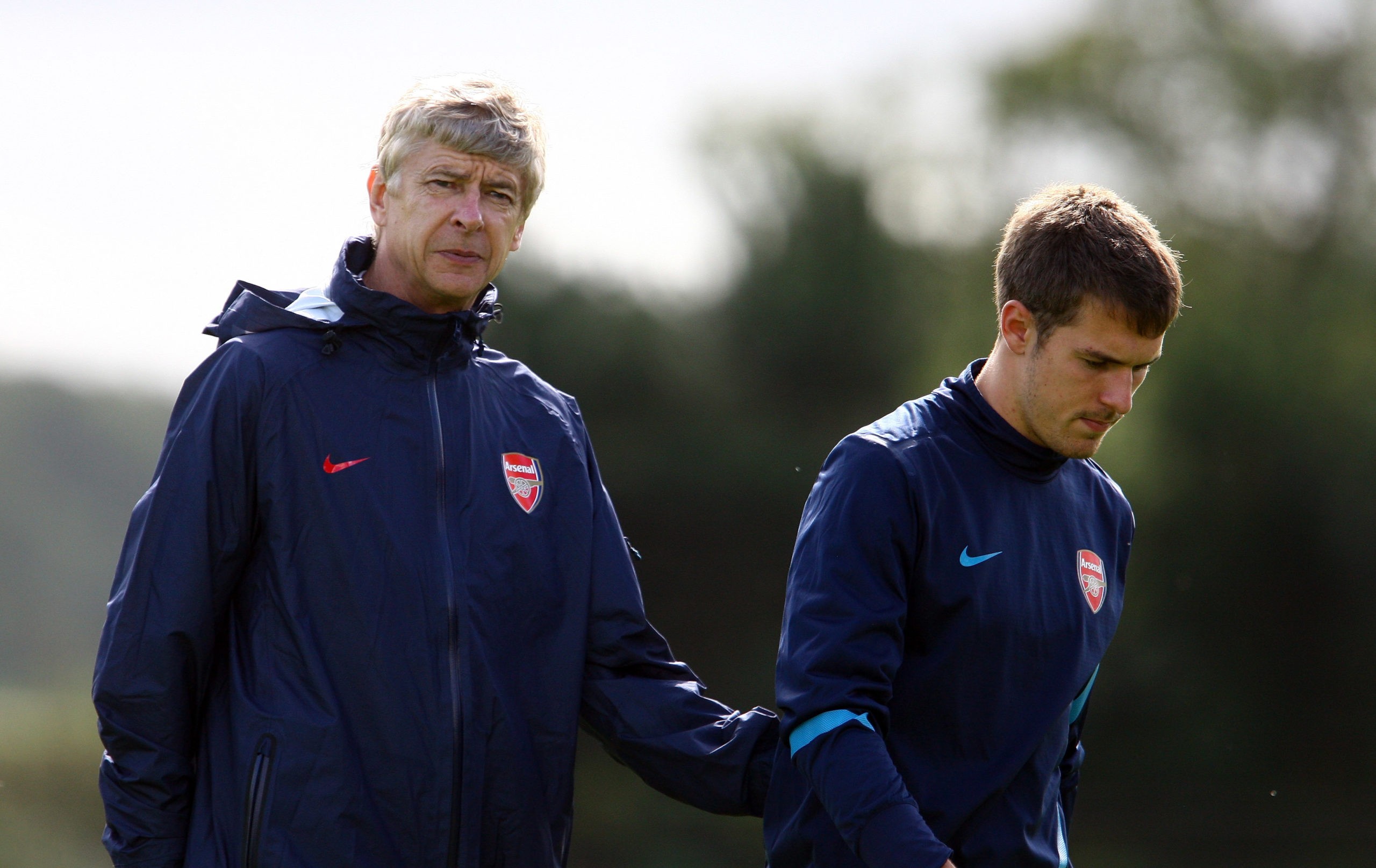 ST ALBANS, ENGLAND - SEPTEMBER 12:  Arsene Wenger, manager of Arsenal with Aaron Ramsey of Arsenal during a training session ahead of their UEFA Champions League Group match against Borussia Dortmund at London Colney on September 12, 2011 in St Albans, England.  (Photo by Julian Finney/Getty Images)