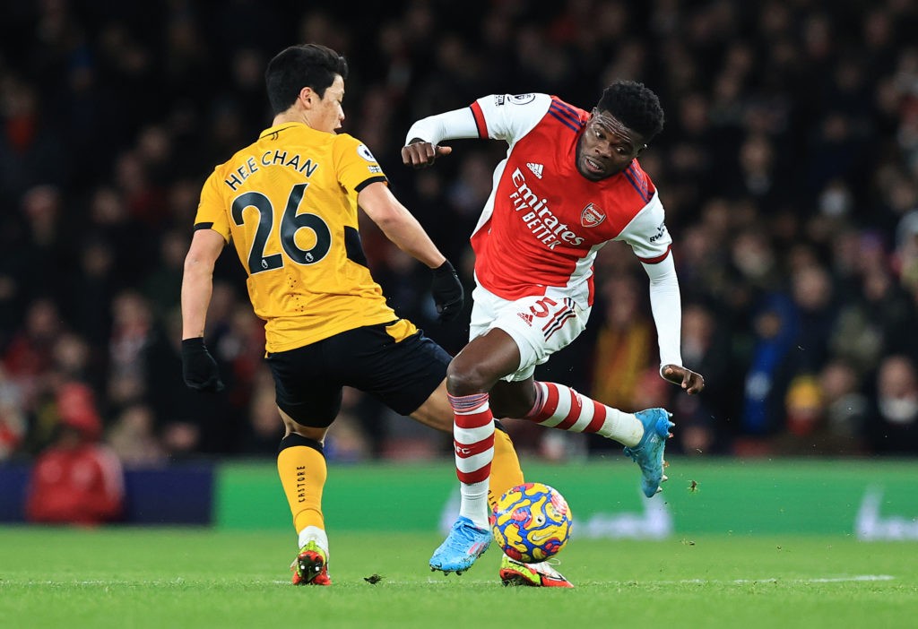 LONDON, ENGLAND: Thomas Partey of Arsenal is tackled by Hwang Hee-chan of Wolverhampton Wanderers during the Premier League match between Arsenal and Wolverhampton Wanderers at Emirates Stadium on February 24, 2022. (Photo by David Rogers/Getty Images)