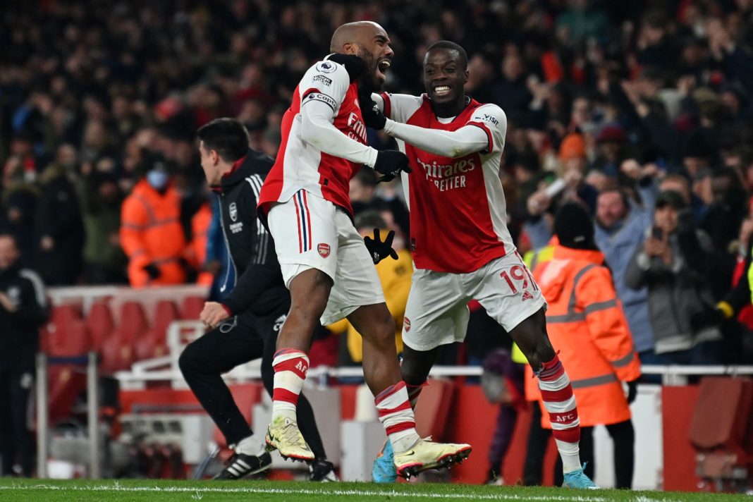 Alexandre Lacazette (L) celebrates with Nicolas Pepe (R) after his shot deflects off Wolverhampton Wanderers' Portuguese goalkeeper Jose Sa (not pictured) for Arsenal's late winning goal during the English Premier League football match between Arsenal and Wolverhampton Wanderers at the Emirates Stadium in London on February 24, 2022. (Photo by GLYN KIRK/AFP via Getty Images)