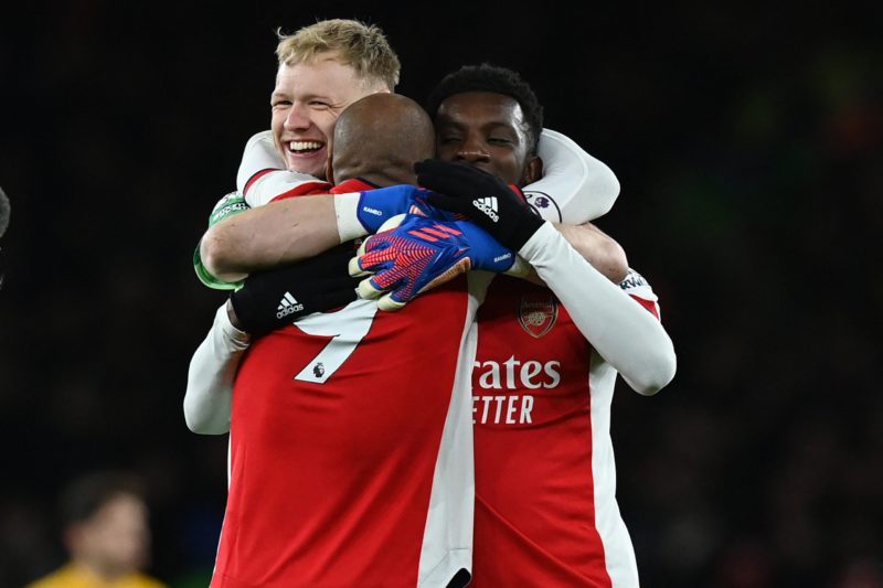 Arsenal's French striker Alexandre Lacazette (C) celebrates with Arsenal's English goalkeeper Aaron Ramsdale (L) and Arsenal's English striker Eddie Nketiah (R) on the final whistle in the English Premier League football match between Arsenal and Wolverhampton Wanderers at the Emirates Stadium in London on February 24, 2022. - Arsenal won the game 2-1. (Photo by GLYN KIRK/AFP via Getty Images)