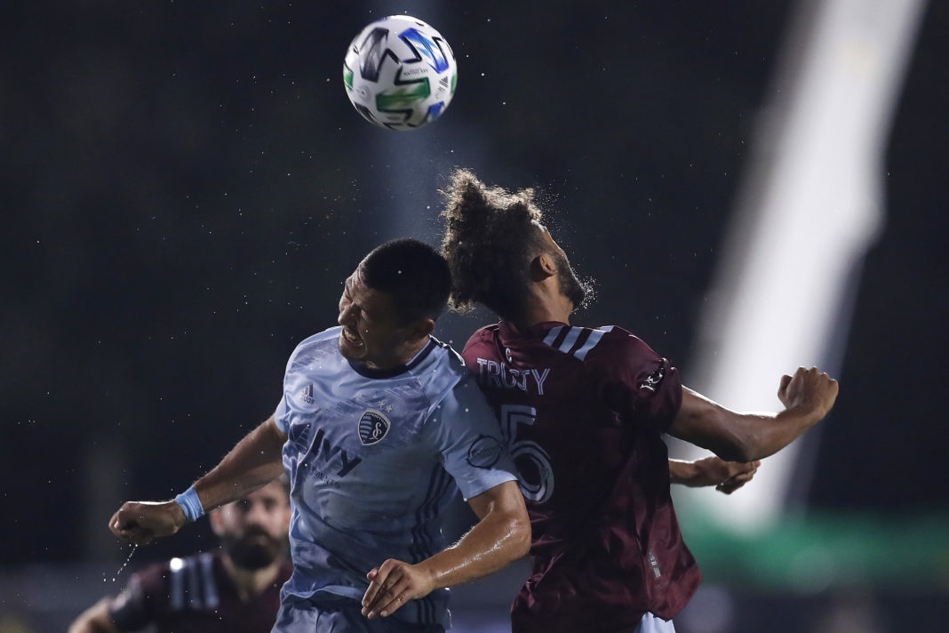 REUNION, FLORIDA: Roger Espinoza #15 of Sporting Kansas City and Auston Trusty #5 of Colorado Rapids battle for a header during a Group D match as part of the MLS Is Back Tournament at ESPN Wide World of Sports Complex on July 17, 2020. (Photo by Michael Reaves/Getty Images)