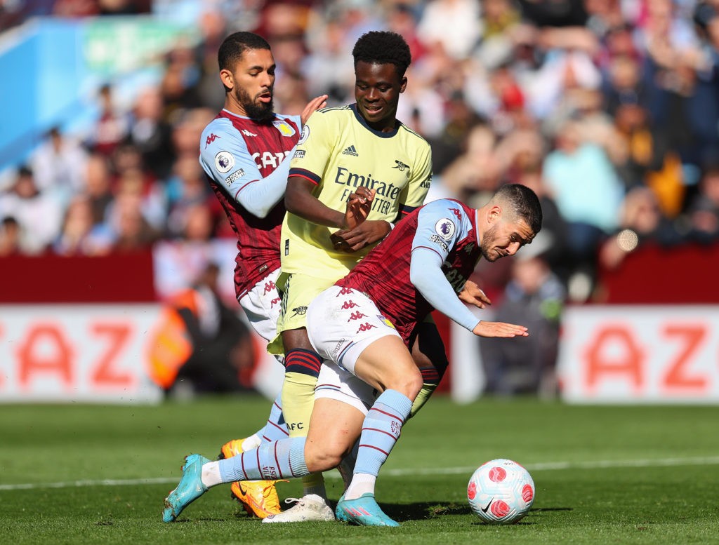 BIRMINGHAM, ENGLAND: Bukayo Saka of Arsenal is challenged by Douglas Luiz and Emiliano Buendia of Aston Villa during the Premier League match between Aston Villa and Arsenal at Villa Park on March 19, 2022. (Photo by Catherine Ivill/Getty Images)