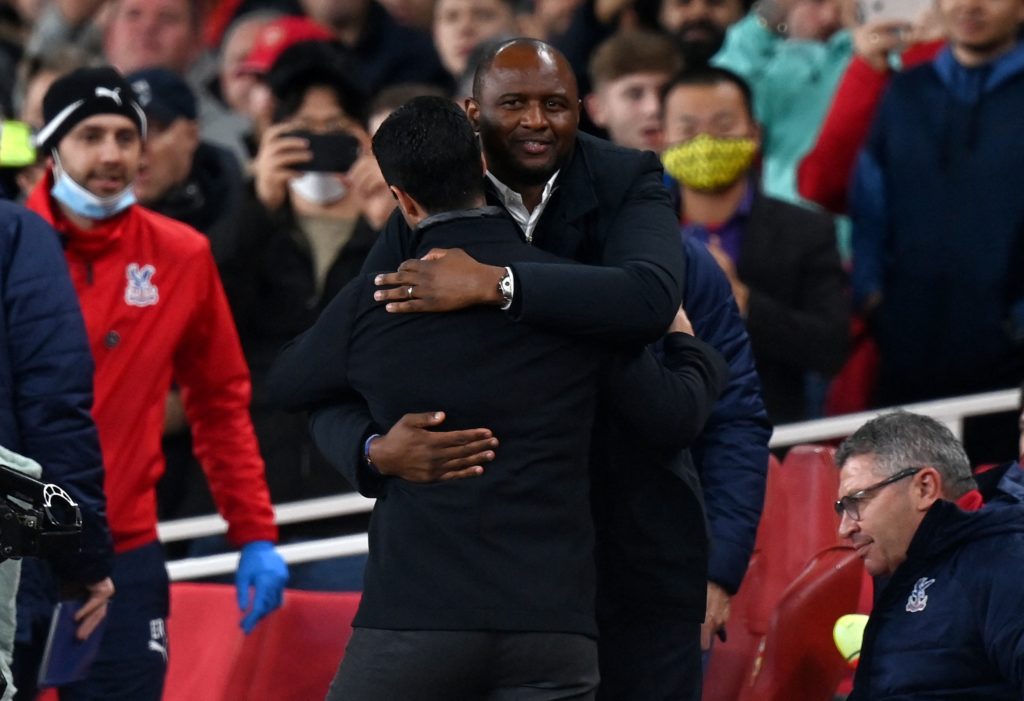 Crystal Palace's French manager Patrick Vieira (R) embraces Arsenal's Spanish manager Mikel Arteta ahead of the English Premier League football match between Arsenal and Crystal Palace at the Emirates Stadium in London on October 18, 2021. (Photo by GLYN KIRK/AFP via Getty Images)