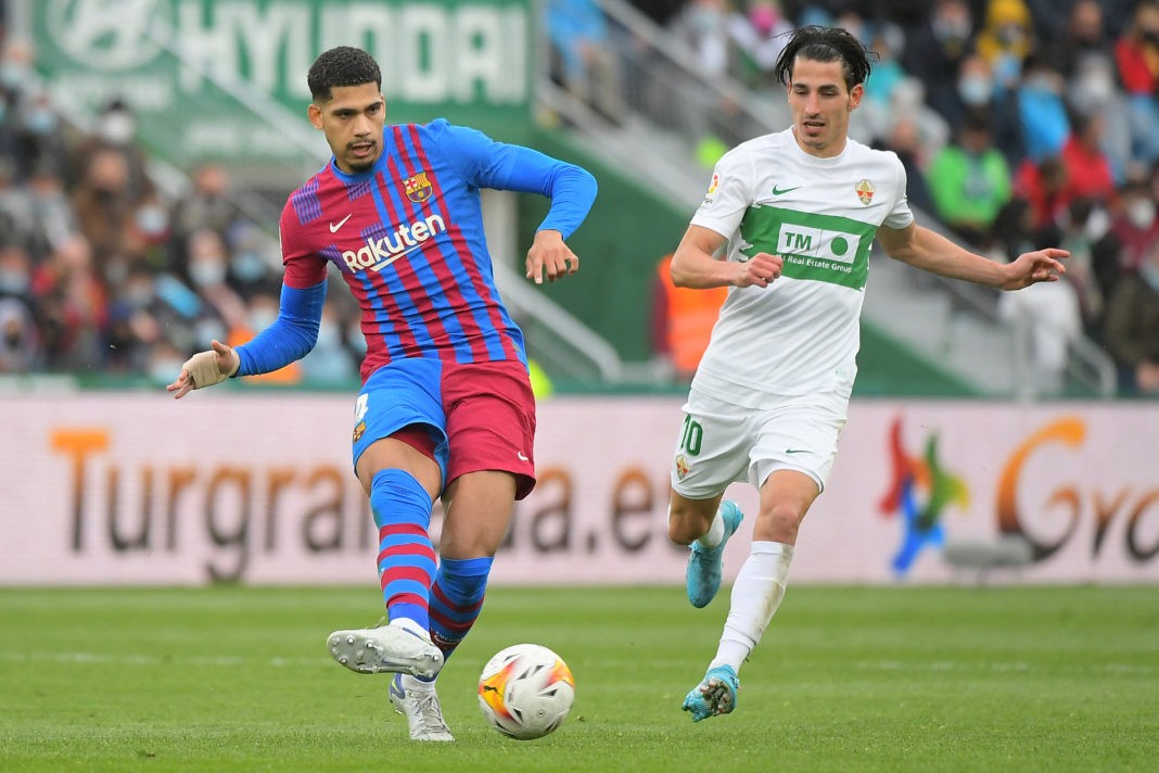 Barcelona's Uruguayan defender Ronald Araujo (L) vies with Elche's Spanish midfielder Pere Milla during the Spanish league football match between Elche CF and FC Barcelona at the Martinez Valero stadium in Elche on March 6, 2022. (Photo by JOSE JORDAN/AFP via Getty Images)