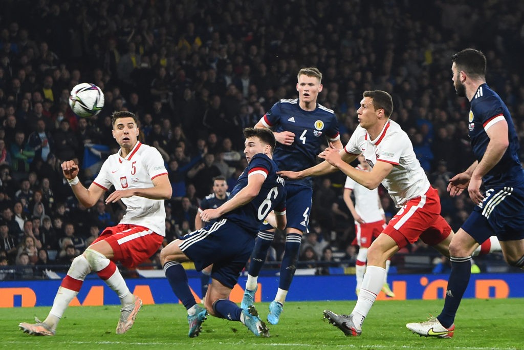 Scotland's defender Kieran Tierney (C) heads home the opening goal during the friendly football match between Scotland and Poland at Hampden Park in Glasgow on March 24, 2022. (Photo by ANDY BUCHANAN / AFP via Getty Images)