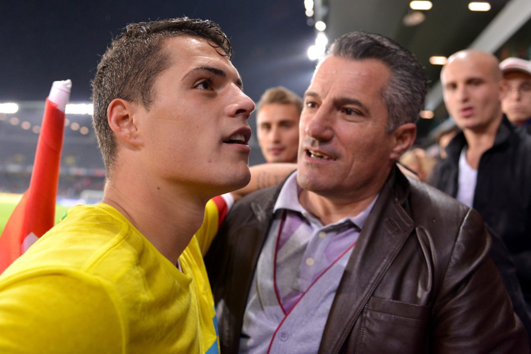 BERN, SWITZERLAND - OCTOBER 15: Granit Xhaka of Switzerland chat with fans and his father Ragip Xhaka after winning the FIFA 2014 World Cup Qualifier match between Switzerland and Slovenia match held at Stade de Suisse on October 15, 2013 in Bern, Switzerland. (Photo by Harold Cunningham/Getty Images)