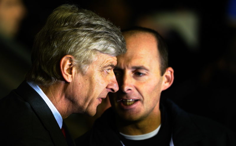 Arsenal's French manager Arsene Wenger (L) speaks to fourth official Mike Dean as he arrives for their English Premier League football match against Wigan Athletic at the DW Stadium in Wigan, north-west England, on December 29, 2010. AFP PHOTO/PAUL ELLIS