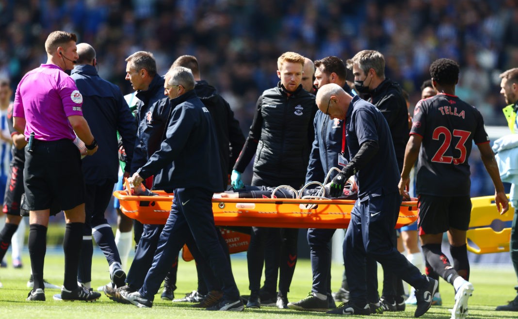 BRIGHTON, ENGLAND: Tino Livramento of Southampton leaves the field after receiving medical treatment during the Premier League match between Brighton & Hove Albion and Southampton at American Express Community Stadium on April 24, 2022. (Photo by Bryn Lennon/Getty Images)