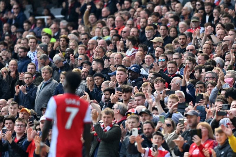 Arsenal fans applaud Arsenal's English midfielder Bukayo Saka during the English Premier League football match between Arsenal and Manchester United at the Emirates Stadium in London on April 23, 2022. (Photo by GLYN KIRK/AFP via Getty Images)