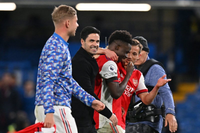 Arsenal's Spanish manager Mikel Arteta (C) celebrates with his players on the pitch after the English Premier League football match between Chelsea and Arsenal at Stamford Bridge in London on April 20, 2022. - Arsenal won the game 4-2. (Photo by GLYN KIRK/AFP via Getty Images)