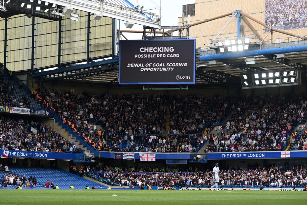The big screen shows a VAR review for a foul by West Ham United England defender Craig Dawson (unseen) on Chelsea's Belgian striker Romelu Lukaku (unseen) during the English Premier League soccer match between Chelsea and West Ham United at Stamford Bridge in London on April 24, 2022. (Photo by JUSTIN TALLIS/AFP via Getty Images)