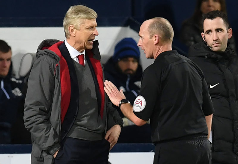 Arsenal's French manager Arsene Wenger (L) has words with English referee Mike Dean during the English Premier League football match between West Bromwich Albion and Arsenal at The Hawthorns stadium in West Bromwich, central England, on December 31, 2017.  / AFP PHOTO / Paul ELLIS 