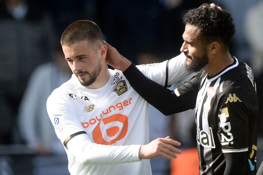 Lille's Kosovar defender Edon Zhegrova (L) is congratulated by Angers' Moroccan forward Sofiane Boufal (R) after the French L1 football match between Angers SCO and Lille LOSC, at the Raymond-Kopa Stadium, in Angers, northwestern France, on April 10, 2022. (Photo by JEAN-FRANCOIS MONIER/AFP via Getty Images)