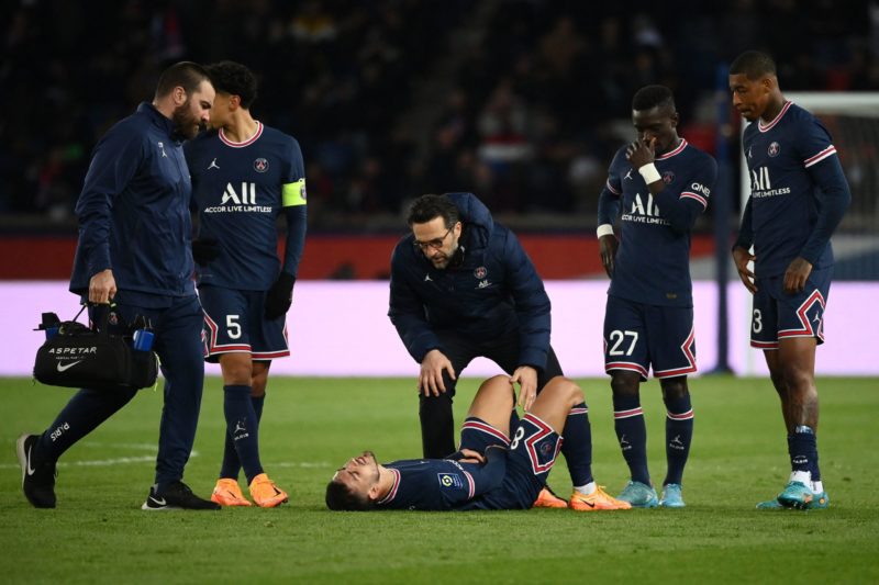 Paris Saint-Germain's Argentinian midfielder Leandro Paredes (C) reacts on the ground following an injury during the French L1 football match between Paris Saint-Germain (PSG) and FC Lorient at the Parc des Princes stadium in Paris on April 3, 2022. (Photo by FRANCK FIFE / AFP) (Photo by FRANCK FIFE/AFP via Getty Images)