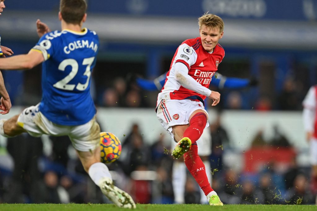 Arsenal's Norwegian midfielder Martin Odegaard (R) has this shot blocked during the English Premier League football match between Everton and Arsenal at Goodison Park in Liverpool, north-west England on December 6, 2021. (Photo by PAUL ELLIS/AFP via Getty Images)